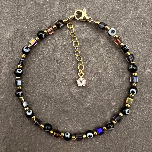 Pulsera negra de mal de ojo con cuentas de cristal cuadradas moradas